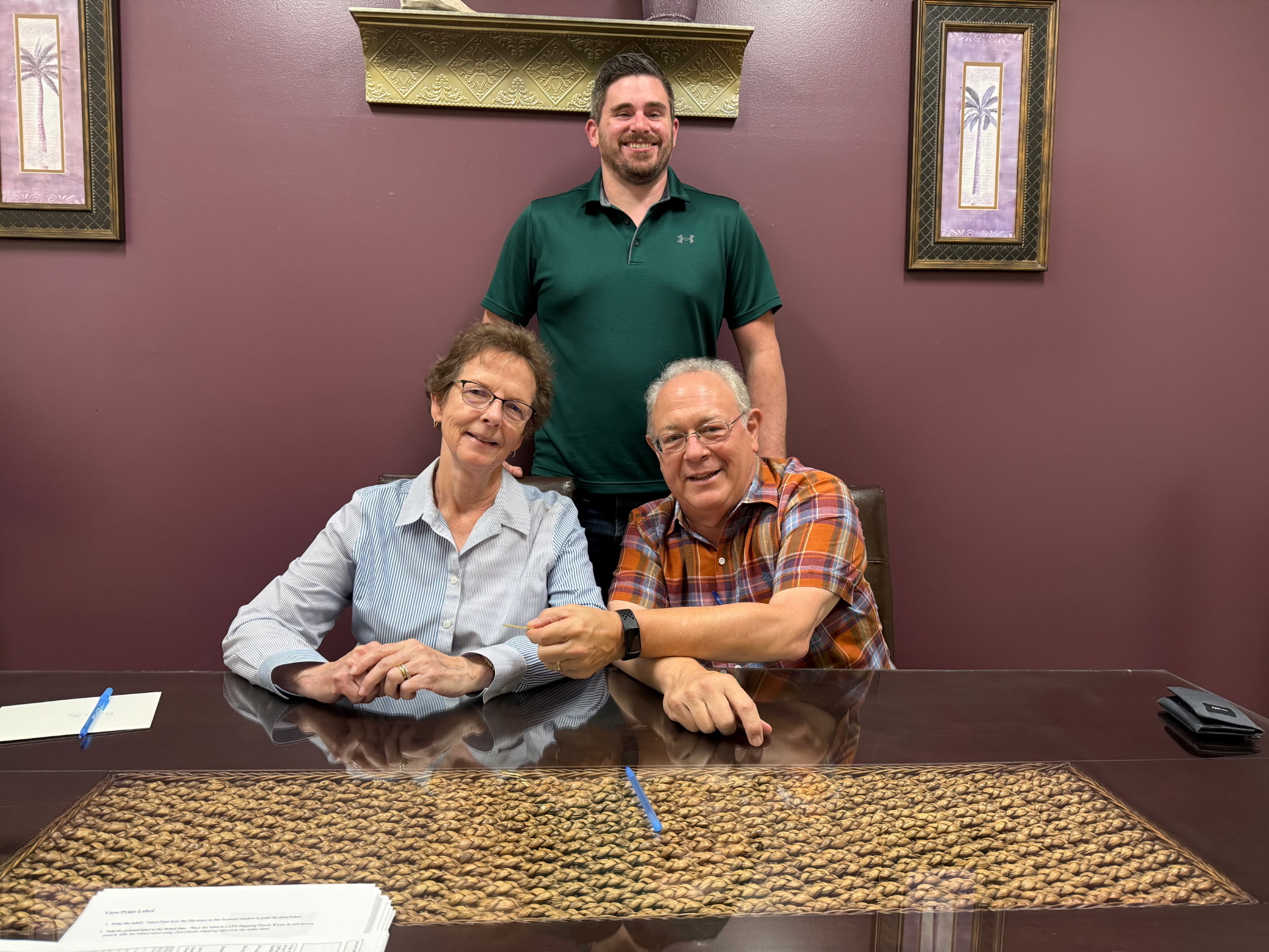 Three people smiling together at the closing table