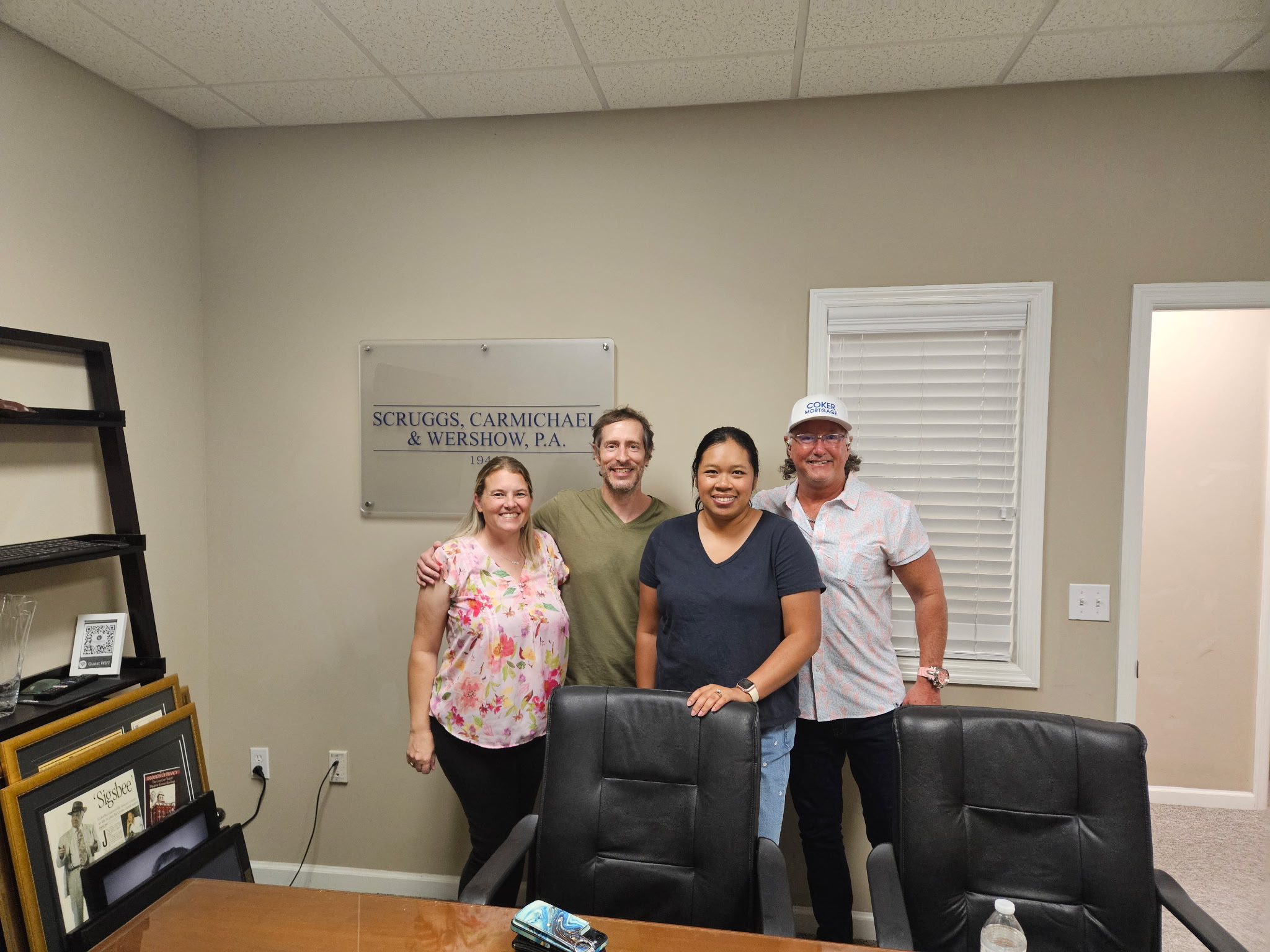 Four people celebrating a closing together