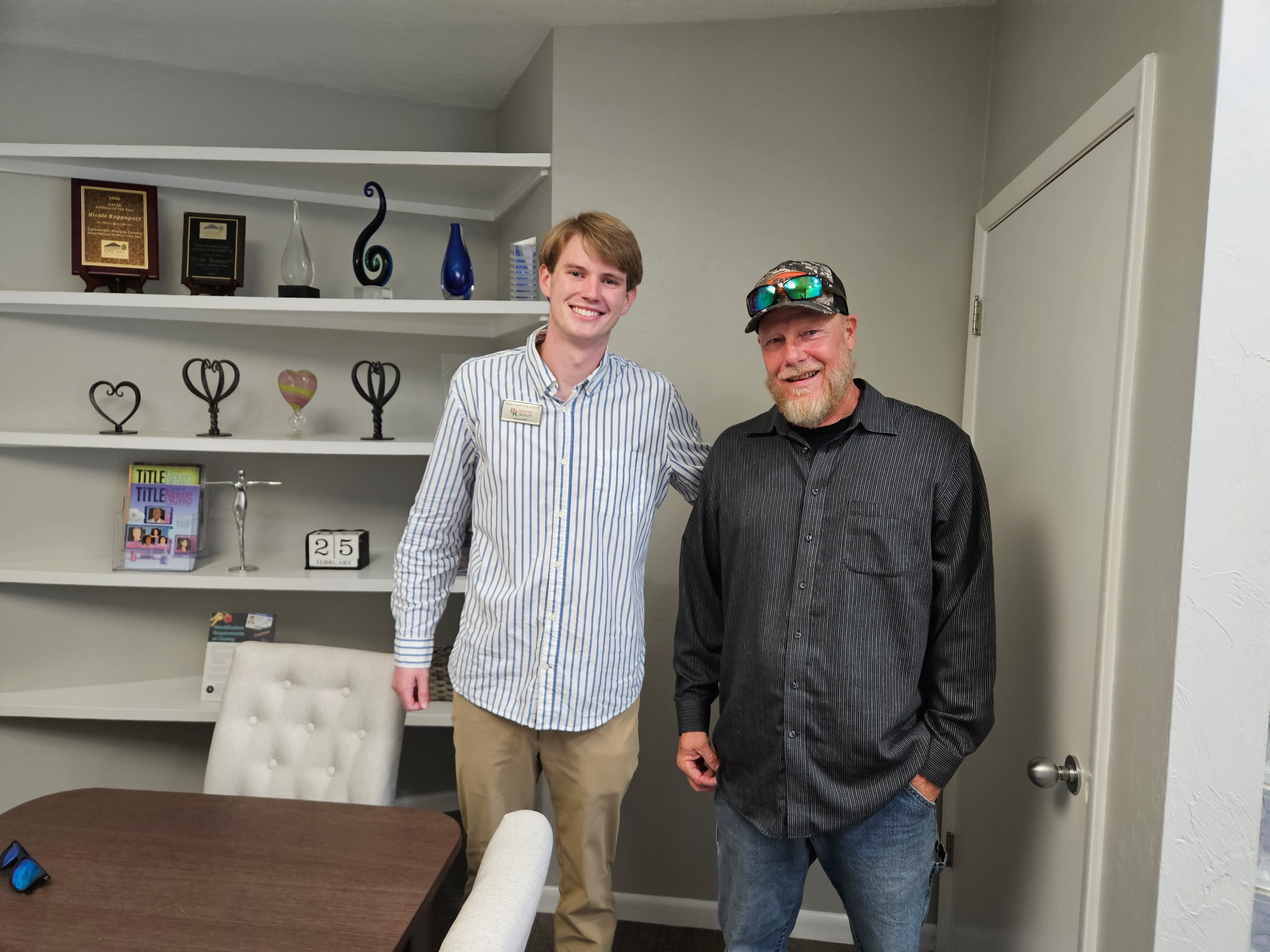Two men smiling together on closing day