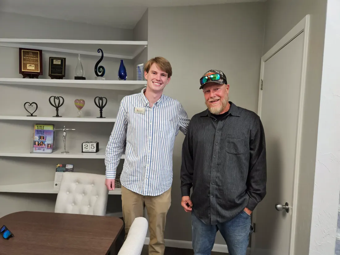 Two men smiling together on closing day